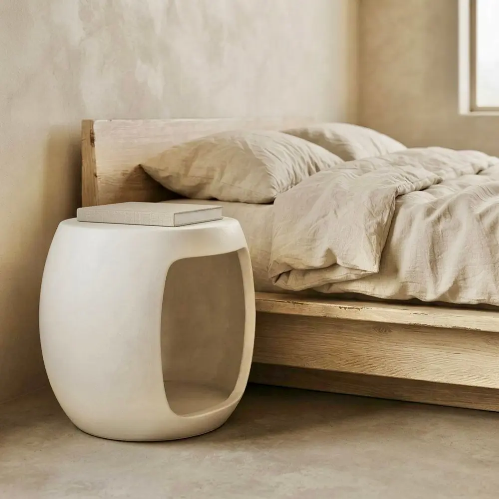 Sinta, barrel-shaped coffee table in white microcement with an open centre