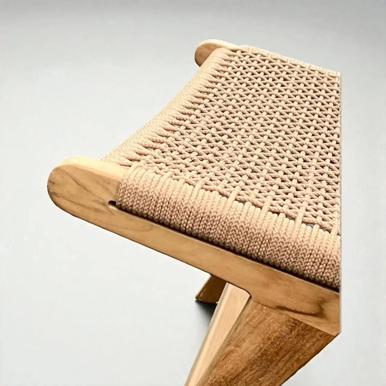 Close-up of solid teak and a woven seat