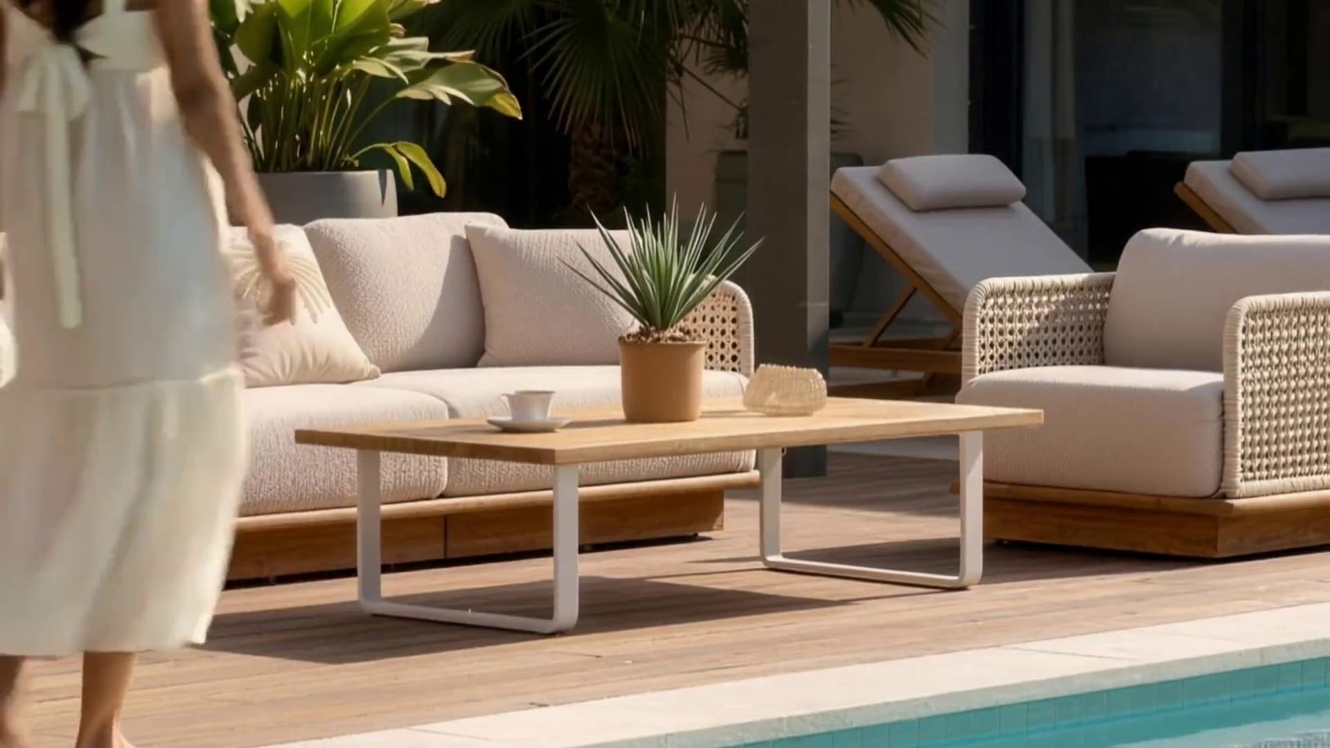 Teak and woven rope outdoor lounge set by a pool